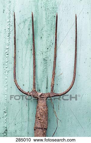 Rusty pitchfork leaning against shed View Large Photo Image Stock Image - Rusty pitchfork leaning against shed. Fotosearch
