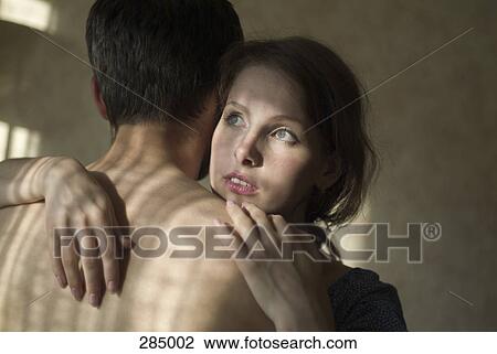 Stock Image - Young couple embracing. Fotosearch