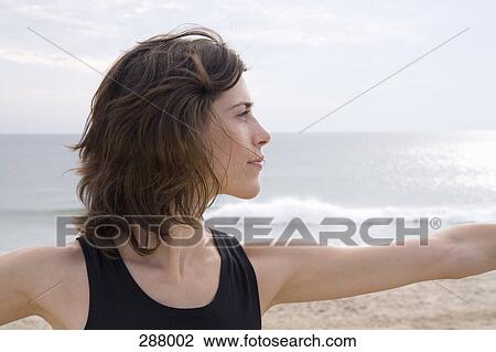 Woman practicing yoga on beach View Large Photo Image Stock Image - Woman practicing yoga on beach. Fotosearch