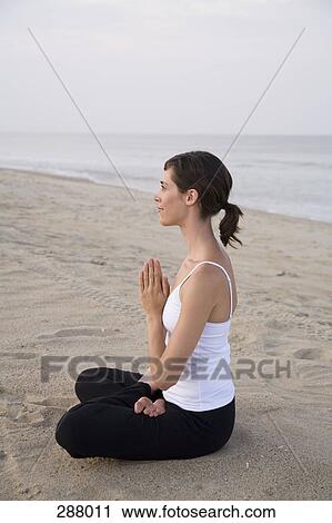 Woman sitting on beach in lotus position View Large Photo Image Stock Image - Woman sitting on beach in lotus position. Fotosearch