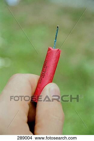 Man holding single firework View Large Photo Image Picture - Man holding single firework. Fotosearch