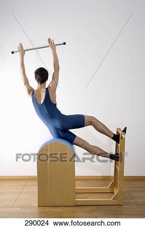 Man exercising on pommel horse and holding pole above head View Large Photo Image Picture - Man exercising on pommel horse and holding pole above head. Fotosearch