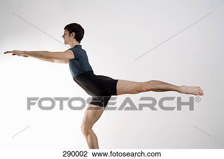 Stock Image - Man practicing Pilates. Fotosearch