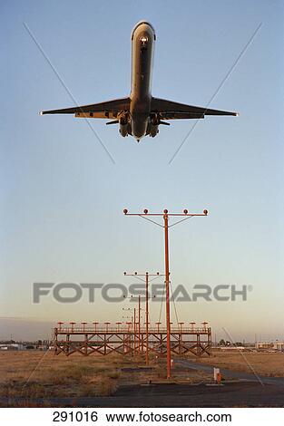 Airplane landing at dusk View Large Photo Image Stock Photograph - Airplane landing at dusk. Fotosearch