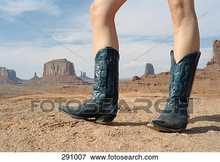 Woman standing in desert wearing cowboy boots View Large Photo Image Stock Photo - Woman standing in desert wearing cowboy boots. Fotosearch