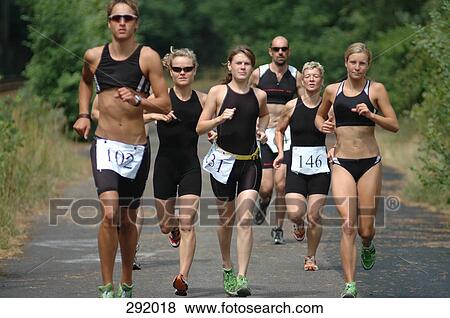 Stock Photo - Group of people running on road in sports race. Fotosearch