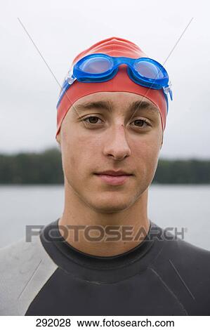 Portrait of triathlete wearing swimming goggles and cap View Large Photo Image Stock Photo - Portrait of triathlete wearing swimming goggles and cap. Fotosearch