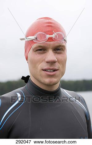 Stock Photo - Portrait of triathlete wearing swimming goggles and cap. Fotosearch