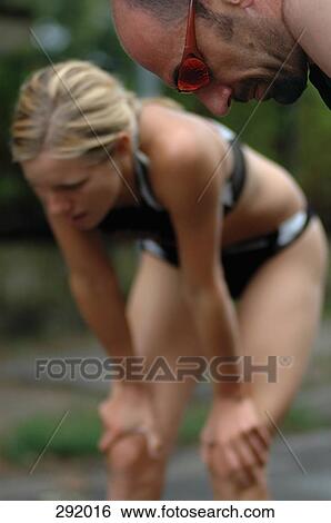 Stock Photograph - Two athletes resting after sports race. Fotosearch