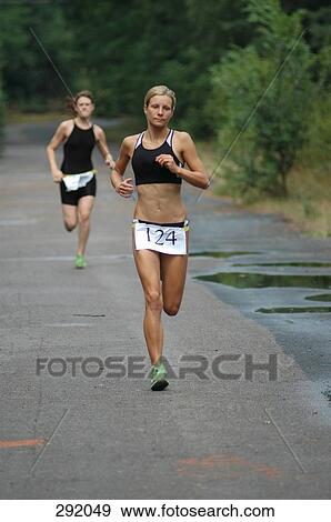 Young woman competing in triathlon View Large Photo Image Stock Photo - Young woman competing in triathlon. Fotosearch