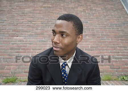 Businessman looking away and smiling View Large Photo Image Stock Image - Businessman looking away and smiling. Fotosearch