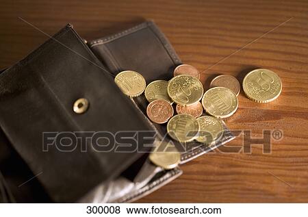 Open wallet with coins spilling onto table View Large Photo Image Stock Photo - Open wallet with coins spilling onto table. Fotosearch