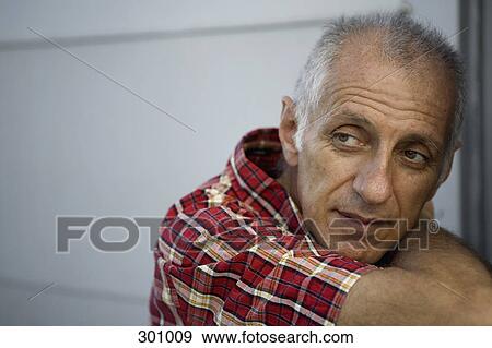 Close-up of man contemplating View Large Photo Image Stock Photo - Close-up of man contemplating. Fotosearch