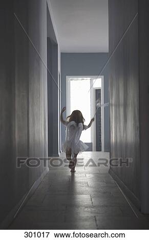 Girl dressed as fairy running along corridor View Large Photo Image Stock Photo - Girl dressed as fairy running along corridor. Fotosearch