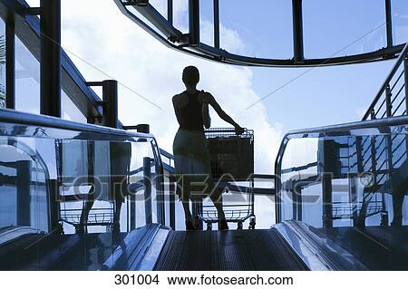 Silhouette of woman on moving walk way View Large Photo Image Picture - Silhouette of woman on moving walk way. Fotosearch