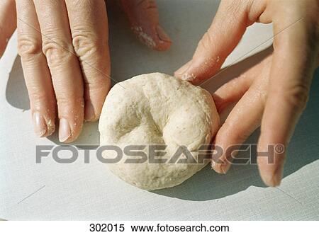 Stock Photography - Close-up of hands kneading dough. Fotosearch