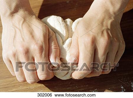 Stock Photograph - Hands kneading dough. Fotosearch