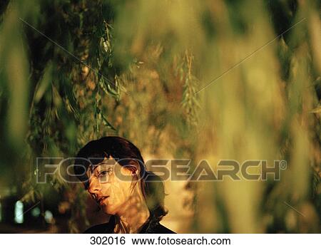 View of woman through branches View Large Photo Image Stock Photograph - View of woman through branches. Fotosearch