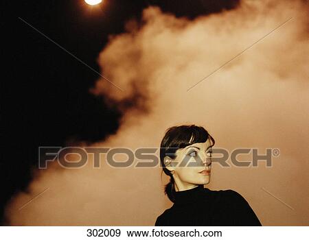 Woman at night with smoky background View Large Photo Image Stock Photo - Woman at night with smoky background. Fotosearch