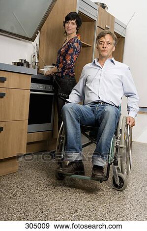 Husband and wife in kitchen, husband in wheelchair View Large Photo Image Stock Photo - Husband and wife in kitchen, husband in wheelchair. Fotosearch