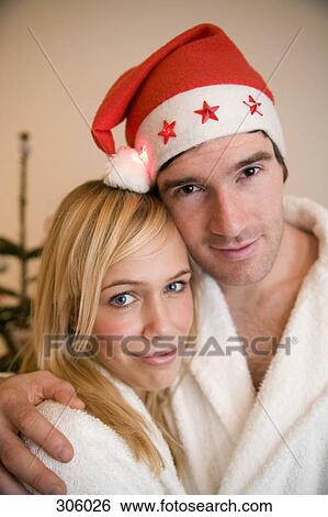 Couple embracing on Christmas morning View Large Photo Image Stock Photograph - Couple embracing on Christmas morning. Fotosearch