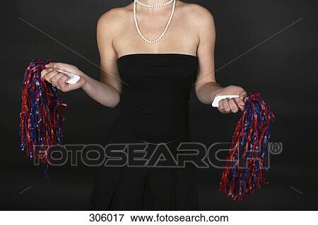 Studio shot of woman holding pom-poms View Large Photo Image Stock Photo - Studio shot of woman holding pom-poms. Fotosearch