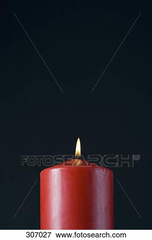 Stock Photo - A red candle. Fotosearch