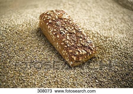 Stock Image - A loaf of bread on top of seed stack. Fotosearch