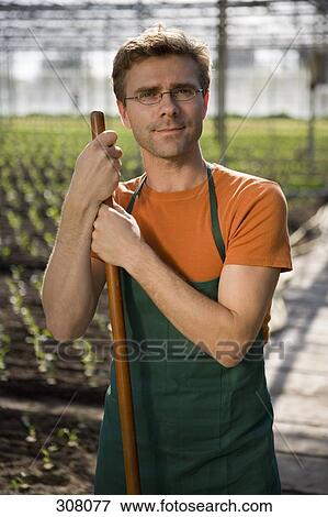 Farm worker posing in greenhouse View Large Photo Image Stock Photo - Farm worker posing in greenhouse. Fotosearch