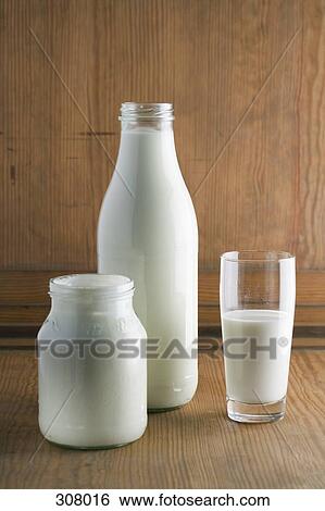 Yoghurt and milk on table View Large Photo Image Stock Photograph - Yoghurt and milk on table. Fotosearch