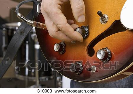 Close up of guitarist tuning guitar View Large Photo Image Stock Image - Close up of guitarist tuning guitar. Fotosearch