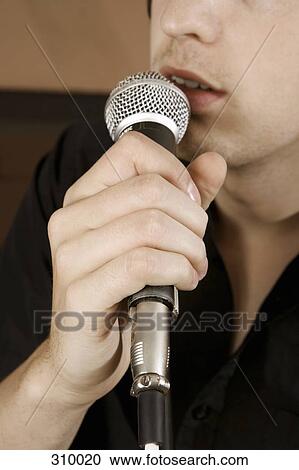 Close-up of singer with microphone View Large Photo Image Stock Image - Close-up of singer with microphone. Fotosearch