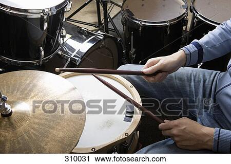 Drummer sitting at drum kit View Large Photo Image Stock Image - Drummer sitting at drum kit. Fotosearch