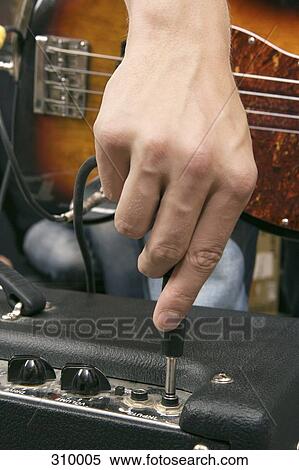 Guitarist plugging in amplifier View Large Photo Image Stock Photography - Guitarist plugging in amplifier. Fotosearch