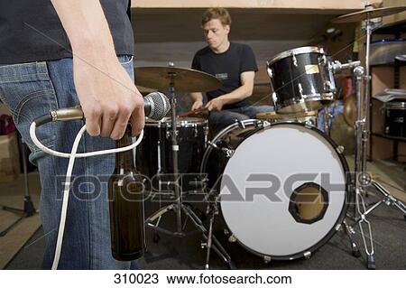 Rock band practicing and drinking beer View Large Photo Image Stock Image - Rock band practicing and drinking beer. Fotosearch