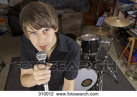 Singer of band practicing in studio View Large Photo Image Stock Image - Singer of band practicing in studio. Fotosearch