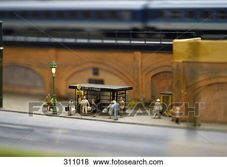 Stock Photo - Model of commuters waiting at bus stop. Fotosearch