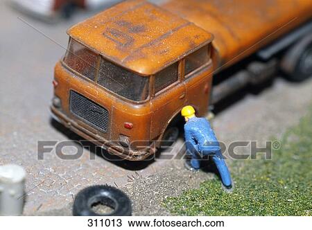 Model of man changing tire on truck View Large Photo Image Stock Image - Model of man changing tire on truck. Fotosearch