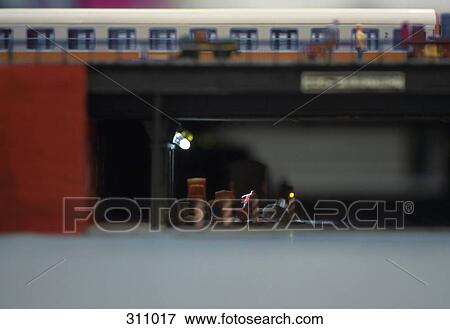 Model of manual worker digging below train on bridge View Large Photo Image Stock Photo - Model of manual worker digging below train on bridge. Fotosearch