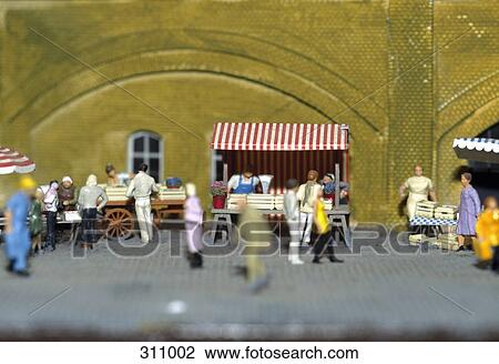 Model of people shopping at market stalls in town square View Large Photo Image Stock Image - Model of people shopping at market stalls in town square. Fotosearch