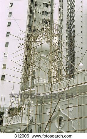 Stock Photograph - Bamboo scaffolding surrounding mosque. Fotosearch
