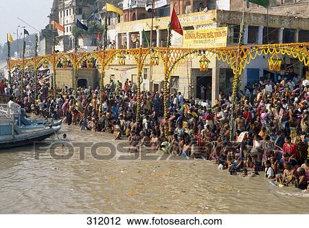 Stock Image - People at festival on riverbank, India. Fotosearch