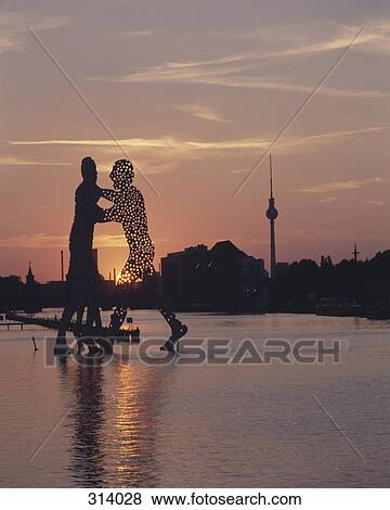 Stock Photo - Molecule Man sculpture on Spree River, Berlin, Germany. Fotosearch