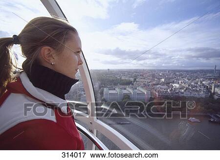 Woman looking at view of London from Millennium Wheel, London, England View Large Photo Image Stock Photo - Woman looking at view of London from Millennium Wheel, London, England. Fotosearch