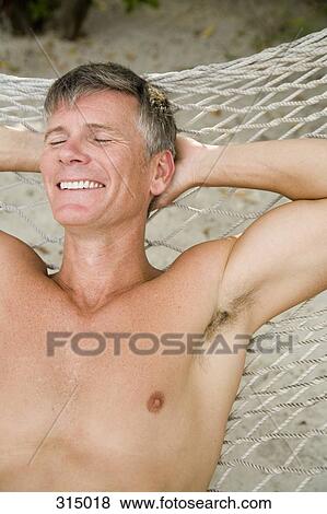 Mature man lying down on hammock with eyes closed View Large Photo Image Stock Photo - Mature man lying down on hammock with eyes closed. Fotosearch