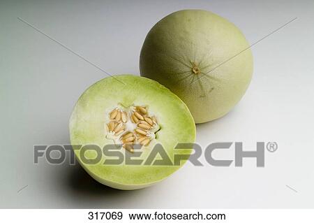 Honeydew melon cut in half View Large Photo Image Stock Photo - Honeydew melon cut in half. Fotosearch