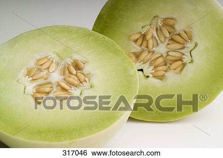 Honeydew melon cut in half View Large Photo Image Stock Photograph - Honeydew melon cut in half. Fotosearch