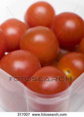 Pile of tomatoes in plastic container View Large Photo Image Stock Photo - Pile of tomatoes in plastic container. Fotosearch