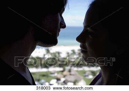 Stock Image - Young couple about to kiss. Fotosearch