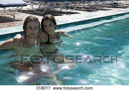 Young couple embracing in swimming pool View Large Photo Image Stock Photo - Young couple embracing in swimming pool. Fotosearch